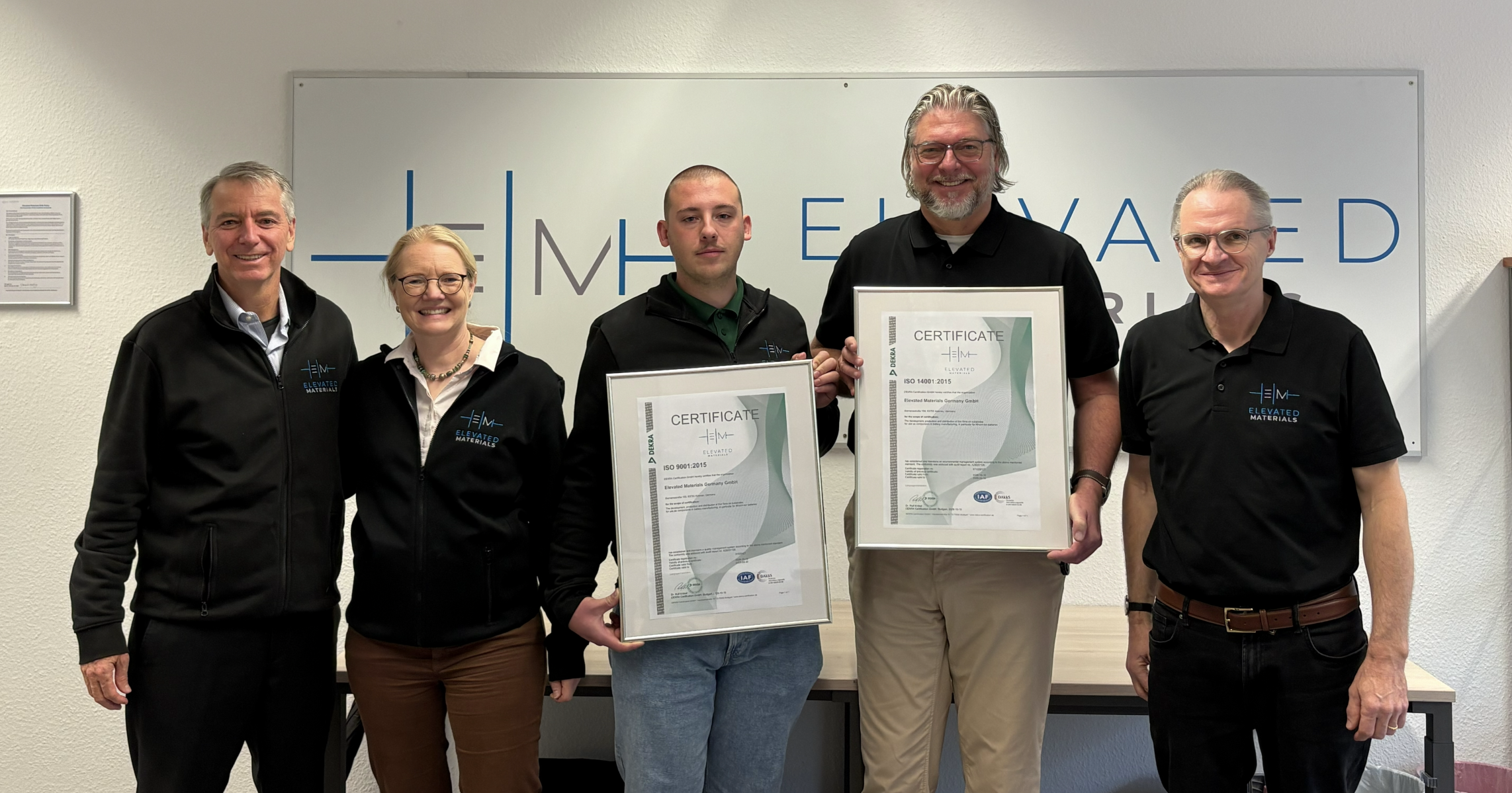 CEO Jim Cushing, Program Manager Andrea Pinnow, Quality Engineer Leon Herrmann, EHS Manager Maik Sarnes and Managing Director Robert Schreutelkamp pose with the ISO 9001:2015 and ISO 14001:2015 certificates.